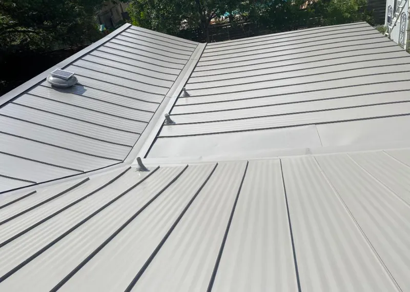 Solar attic fan installed on a metal roof for Roof Ventilation in Milwaukee